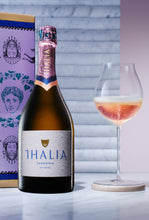 Load image into Gallery viewer, Bottle and glass of Thalia sparkling Rose wine next to purple gift box